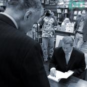 Ralph Nader discusses civic action while Al Gore sign's his book.