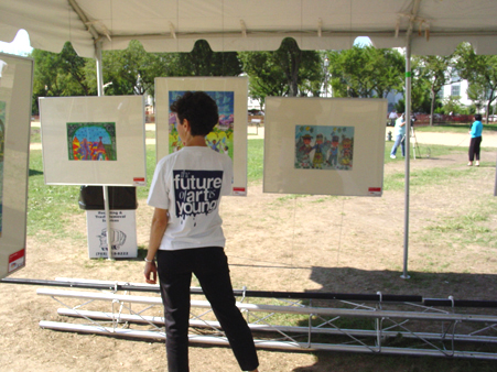 ICAF volunteer looks at 2003 Art Olympiad artwork display at the festival