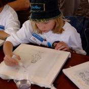 ICAF Young Artist concentrates on her silk painting project in the Arts and Crafts tent, September 11, 2003
