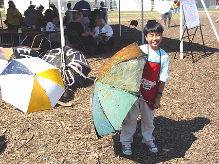 Young Artist from Malaysia proudly displays his Peace Parasol, September 11, 2003