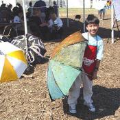 Young Artist from Malaysia proudly displays his Peace Parasol, September 11, 2003