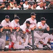 The Red Sox dugout looks on to see if the ball will be a foul or fair play.