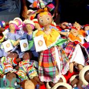 A colorful handmade doll in authentic Haitian garb.