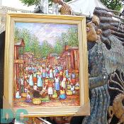 Vivid scenes from everyday activites is a popular theme through Haitian Artwork.  Also, the bronze statue beside this Monet-like piece offers another facet of artistic medium.